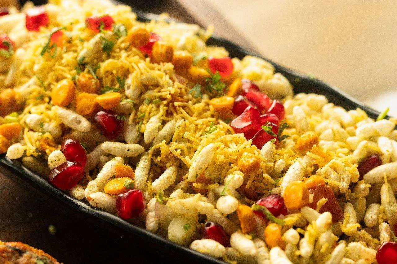 A close-up of Bombay bhel with pomegranate and sev.